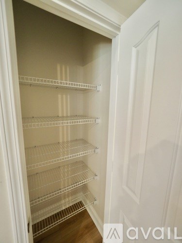 A kitchen with wooden cabinets and a white island.