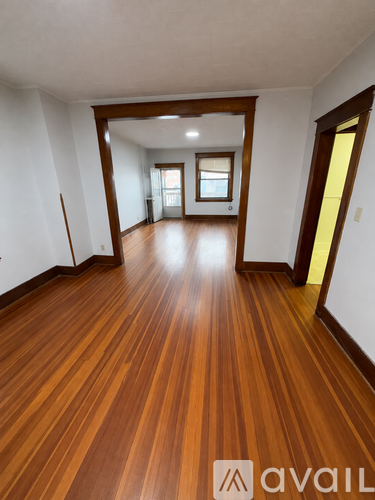 A room with wooden floors and white walls.