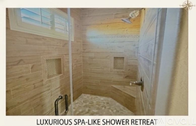 A spa-like shower retreat with a wooden wall and a glass door.