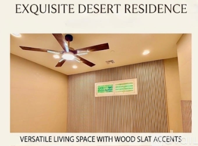 A room with a ceiling fan and a sign that says "EXQUISITE DESERT RESIDENCE" and "VERSATILE LIVING SPACE WITH WOOD SLAT ACCENTS".