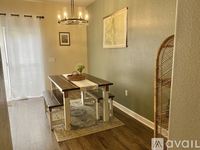 A dining room with a wooden table and chairs.