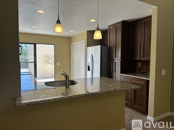 A kitchen with granite countertops and a sink.