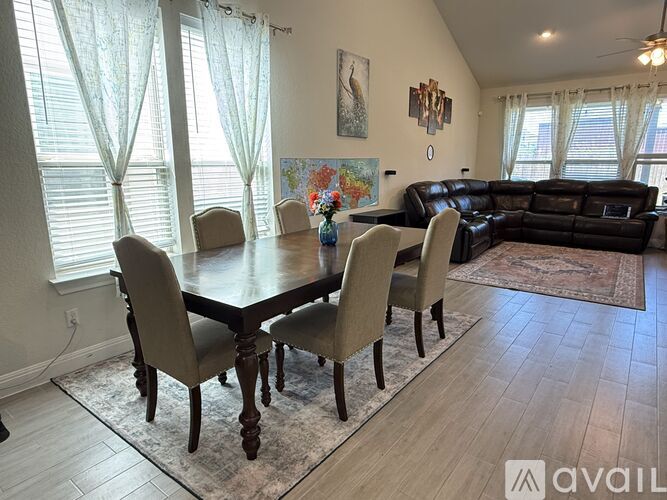 A dining room with a table and chairs.