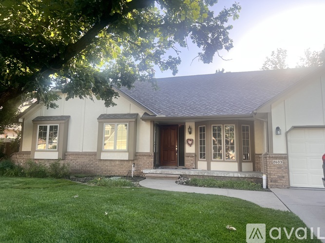 A house with a brown door and windows is for sale.