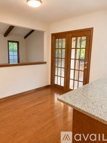 A room with a wooden floor and a door with a window.