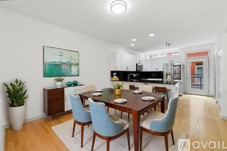 A dining room with a wooden table and blue chairs.