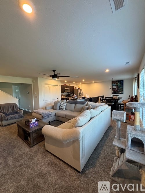 A living room with a white couch and a fireplace.