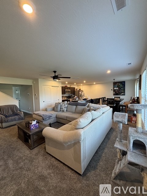 A living room with a white couch and a fireplace.