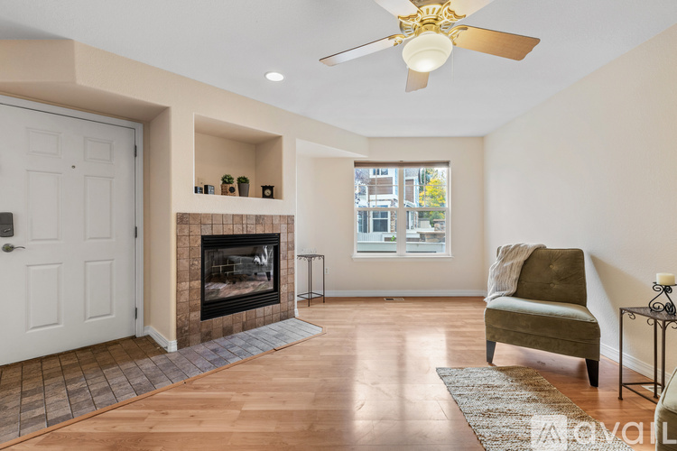 A living room with a fireplace and a chair.