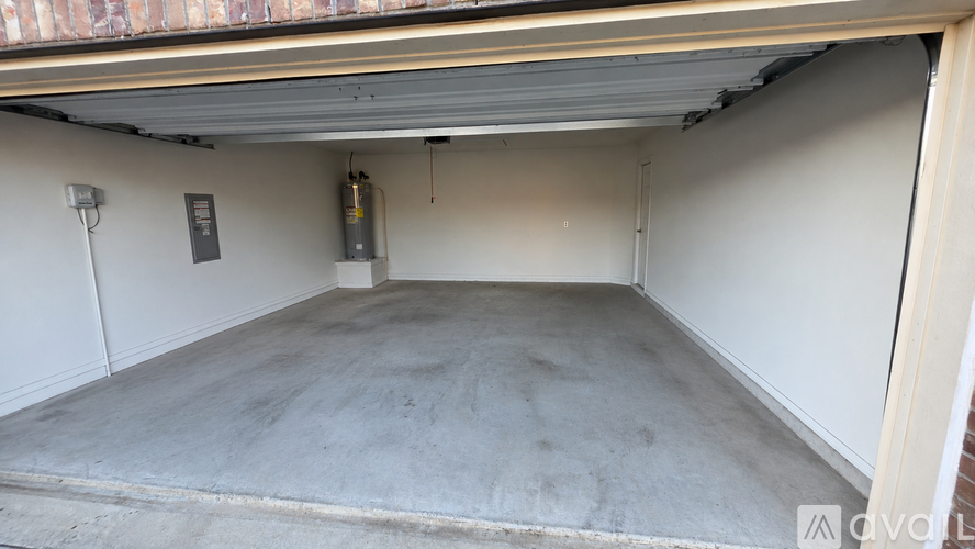A spacious garage with a concrete floor and white walls.