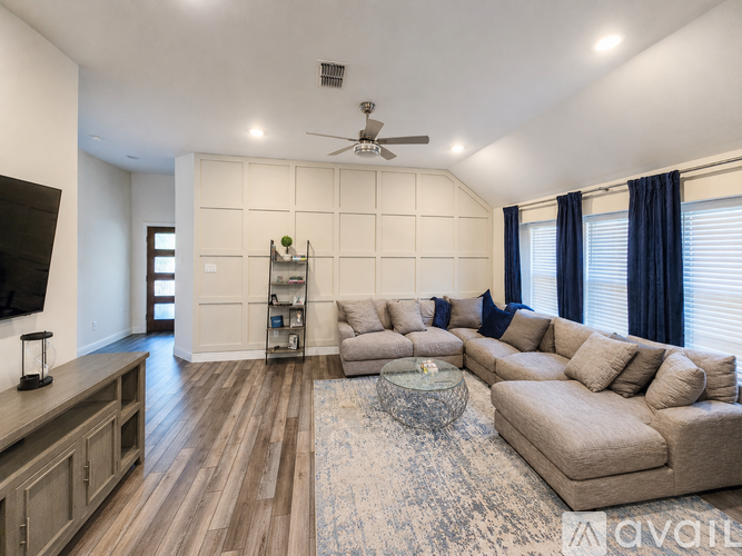 A living room with a large sectional sofa and a coffee table.