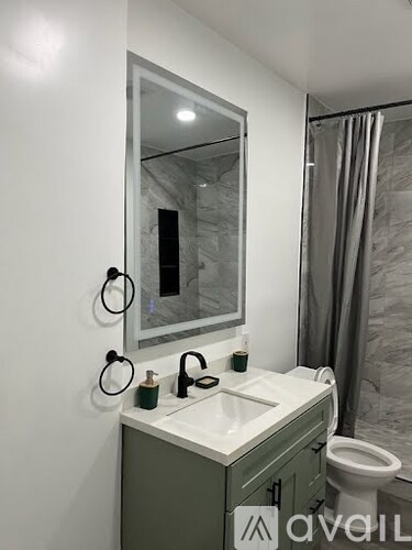 A bathroom with a sink, mirror, and toilet.