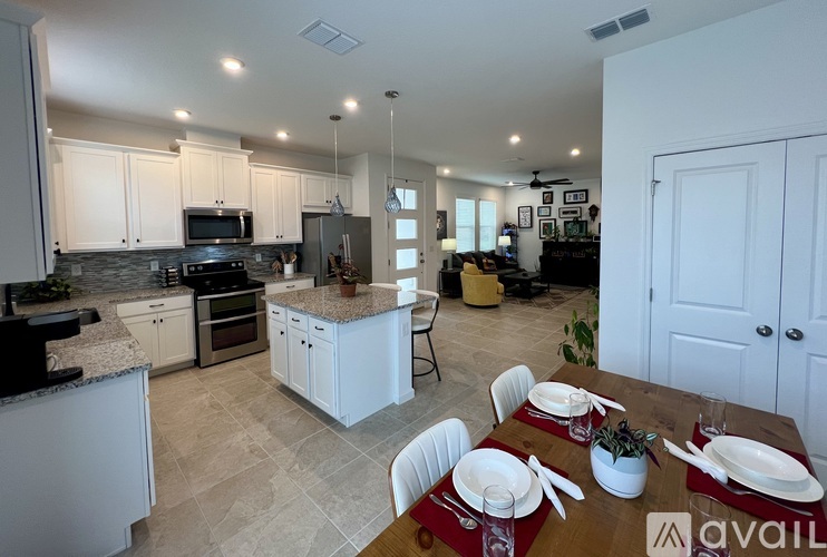 A kitchen with a dining table set for two.