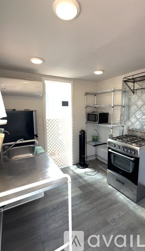 A kitchen with a stove top oven and a microwave.