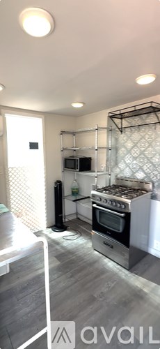 A kitchen with a stove top oven and a microwave.