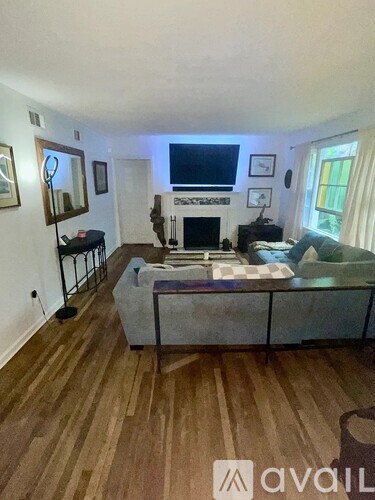 A living room with a fireplace and a couch.
