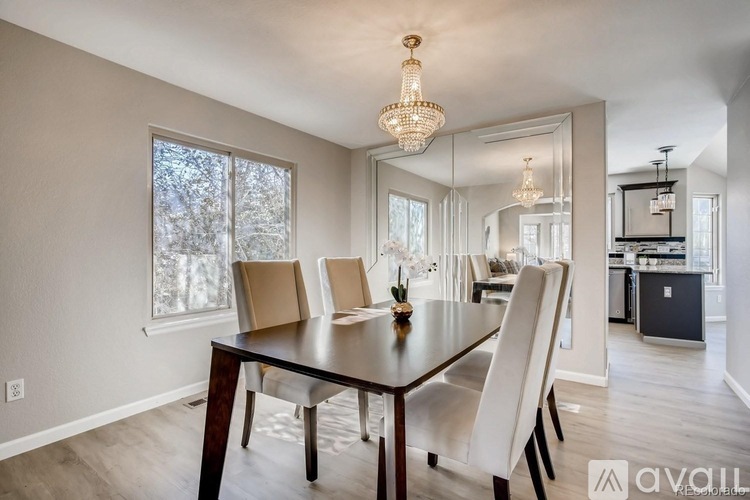 A dining room with a wooden table and chairs.