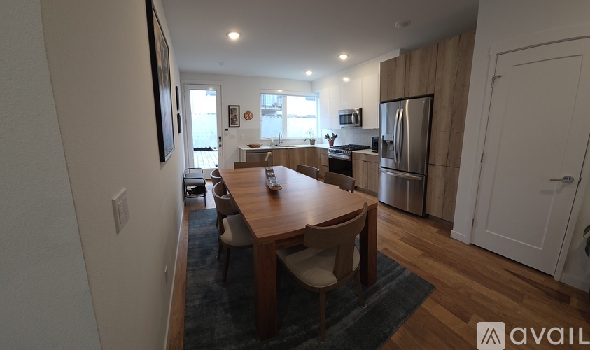 A kitchen with a table and chairs in the middle of the room.