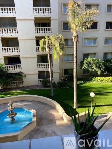 A pool with a fountain in the middle of it.