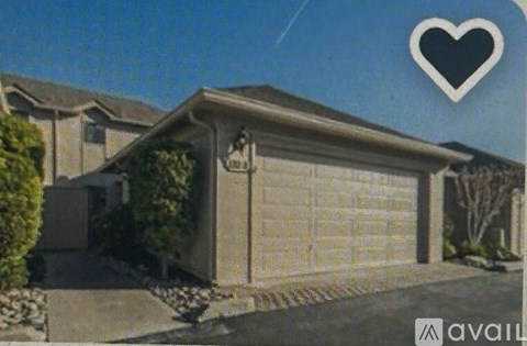 A house with a garage door and a heart symbol in the sky.