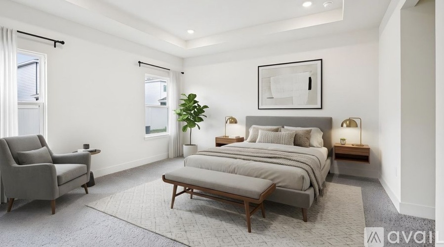 A bedroom with a bed, chair, and lamp.