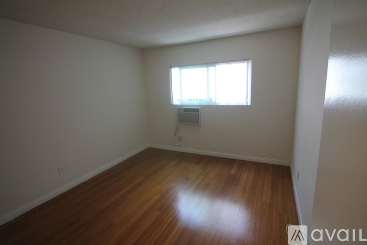 A room with wooden floors and a window.