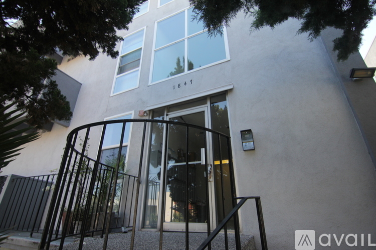 A modern building with a black gate and a glass door.