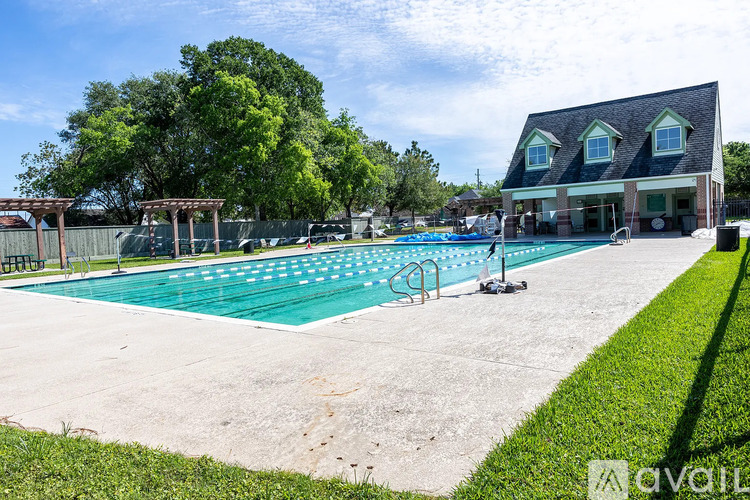 A large outdoor swimming pool with a building in the background.