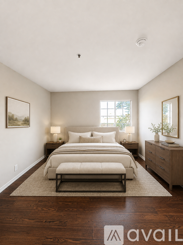 A bedroom with a bed, nightstands, and a rug.