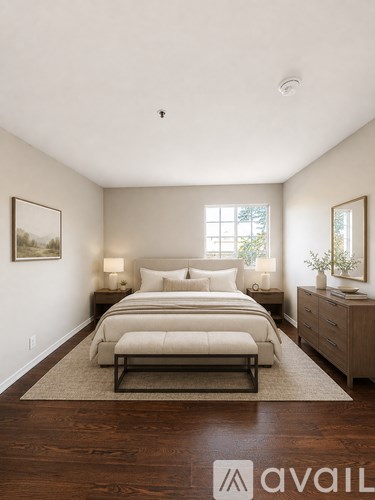 A bedroom with a bed, nightstands, and a rug.
