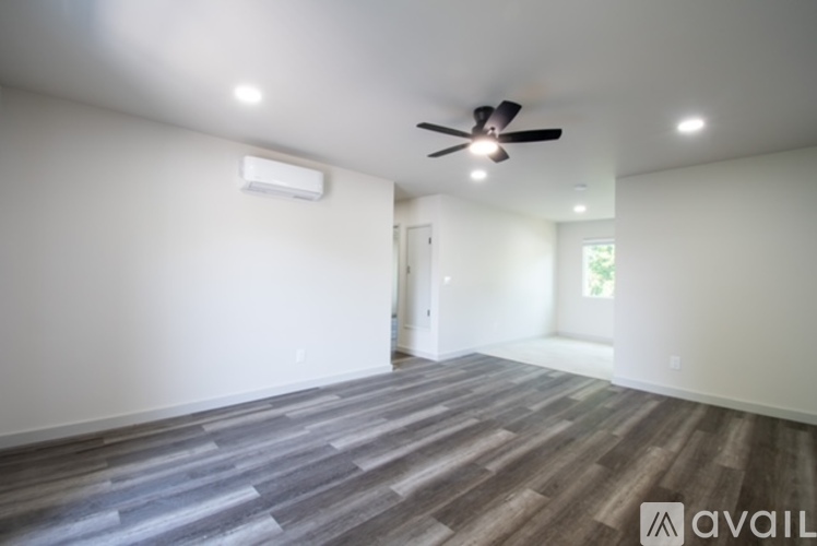 A room with a ceiling fan and a window.