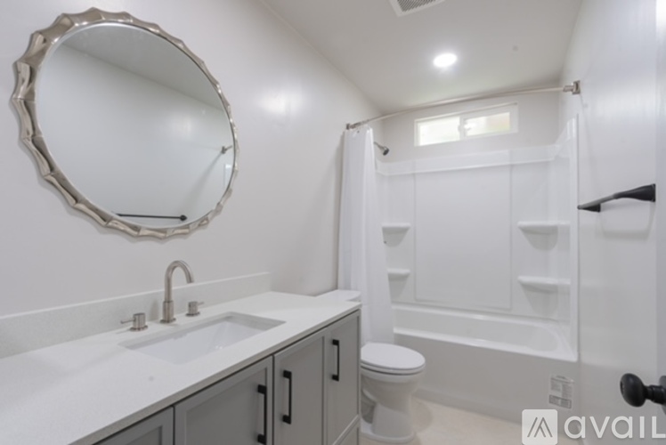 A bathroom with a white sink, toilet, and bathtub.