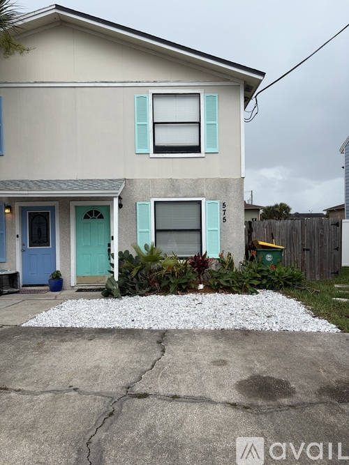A house with a blue door and a white window.