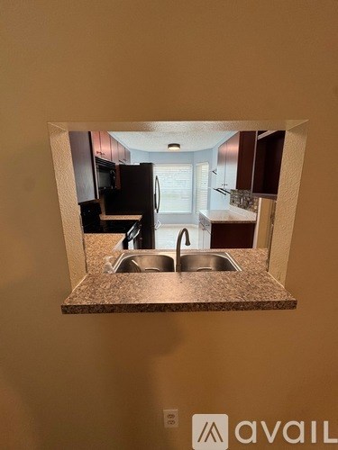 A kitchen with a sink and a window.
