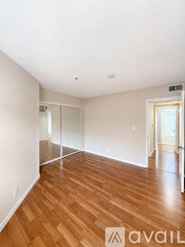 A room with wooden floors and a sliding glass door.