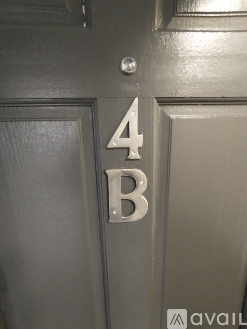 A grey door with a silver number 4B on it.