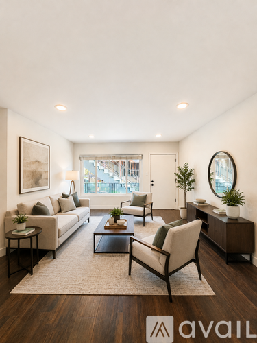 A living room with a couch, chairs, and a coffee table.