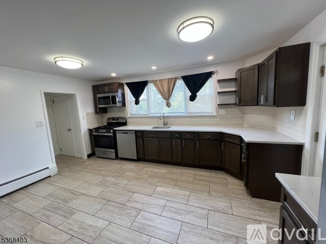 A kitchen with brown cabinets and a white fridge.