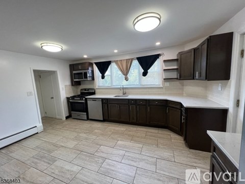 A kitchen with brown cabinets and a white fridge.