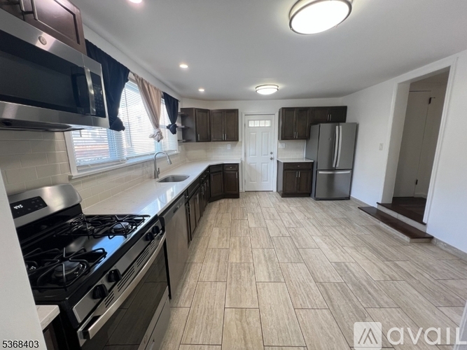 A kitchen with a stove, cabinets, and a countertop.