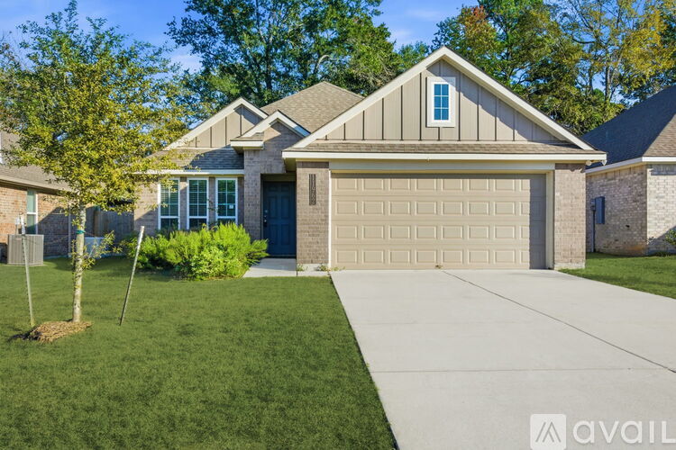 A house with a garage and a driveway in front.