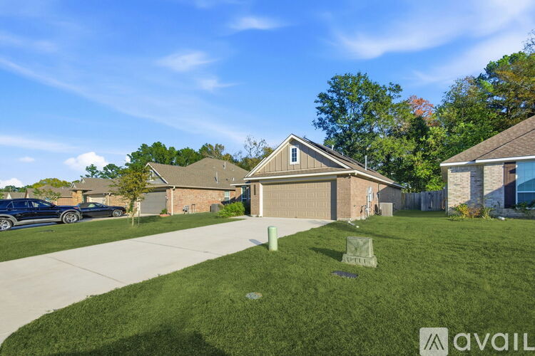A house with a garage and a driveway in front of it.