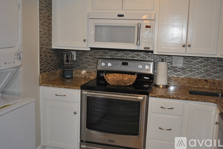 A kitchen with a stove top oven and microwave above it.