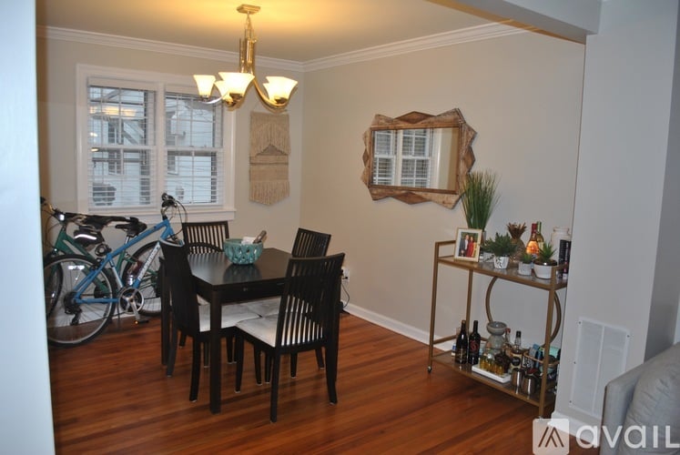 A dining room with a table set for six.