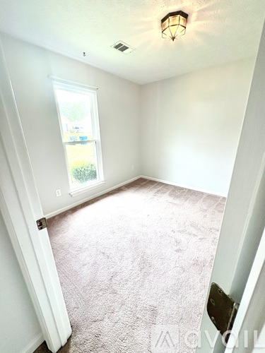 A bedroom with a large bed and a ceiling fan.