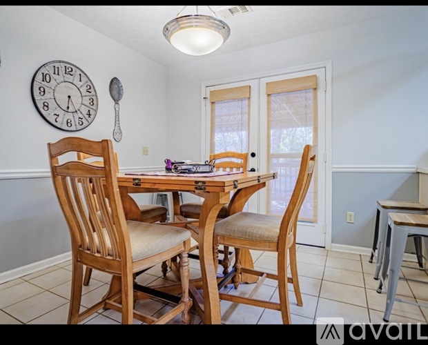 A dining room with a wooden table and chairs.