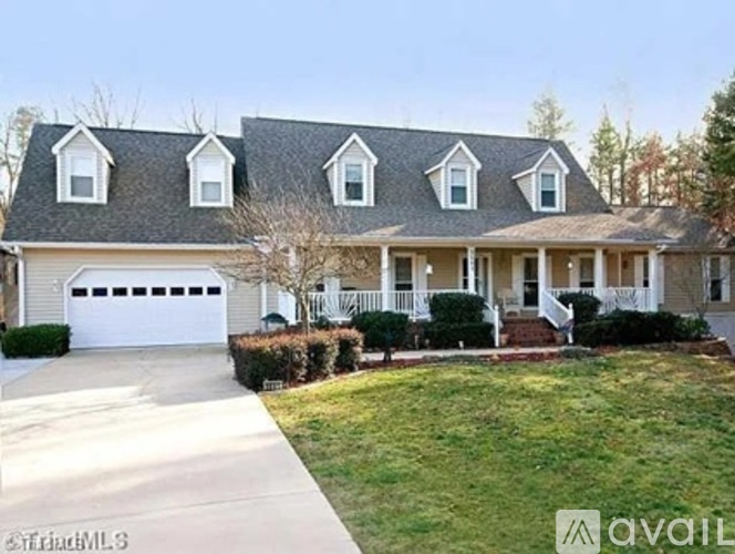 A house with a grey roof and white garage door.