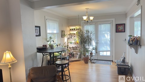 A living room with a dining table and chairs.