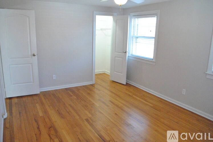 A room with wooden floors and white walls.