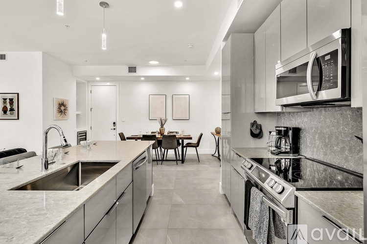 A modern kitchen with a dining table set for four.